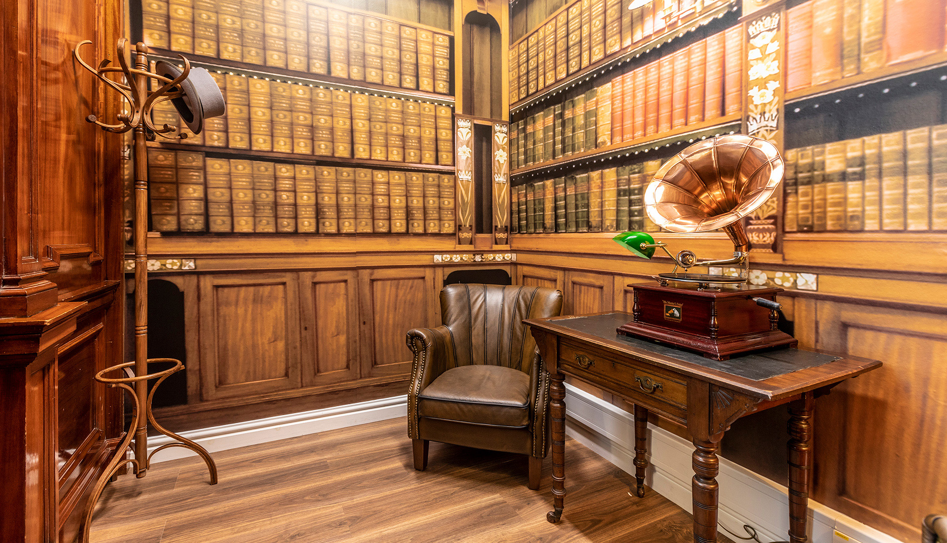 Study with books, leather arm chair and hat stand